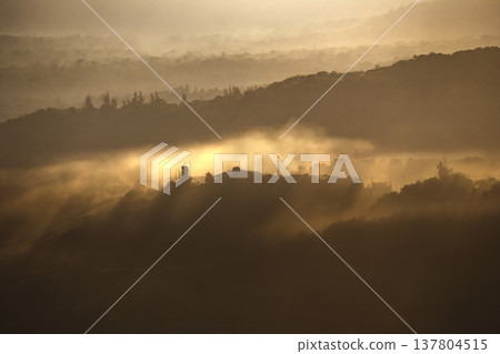 Soft morning light spreads across the peaceful landscape. 137804515