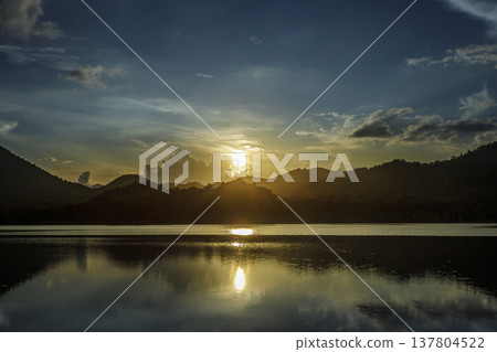 Refreshing natural scenery with mist over mountains and a lake Refreshing natural scenery with mist over mountains and a lake 137804522