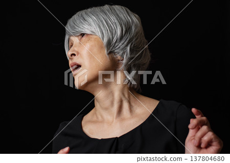 A senior woman who seemed desperate and was saying something. A senior woman who seemed desperate and was saying something. 137804680