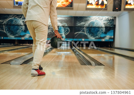 About to throw the ball. Close up view of man that is playing bowling About to throw the ball. Close up view of man that is playing bowling 137804961