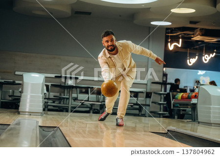 Throwing the ball. Man is playing bowling indoors 137804962