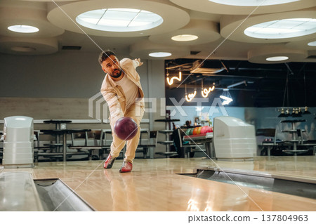 Throwing the ball. Man is playing bowling indoors 137804963