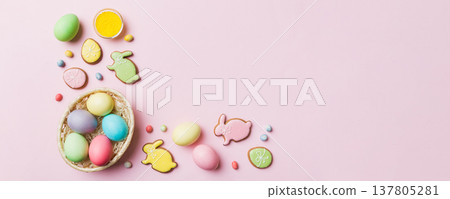 Colorful easter cookies in basket with Multi colors Easter eggs on colored background . Pastel color Easter eggs. holiday concept with copy space 137805281