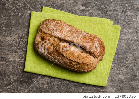 Fresh Homemade Whole Wheat Bread. bread on napkin on rustic background, fresh bread top view 137805330