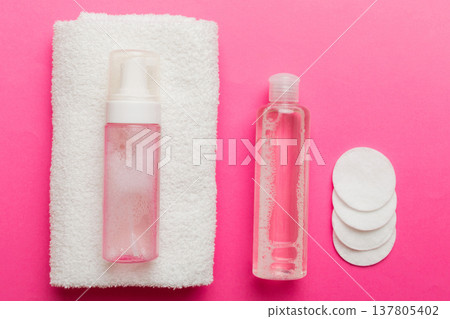 Micellar cleansing water and discs to remove cosmetics and cleanse the skin on colored background. Copy space top view Micellar cleansing water and discs to remove cosmetics and cleanse the skin on colored background. Copy space top view 137805402