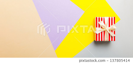 holiday paper present tied yellow ribbon bow top view with copy space. Flat lay holiday background. Birthday or christmas present. Christmas gift box concept with copy space 137805414
