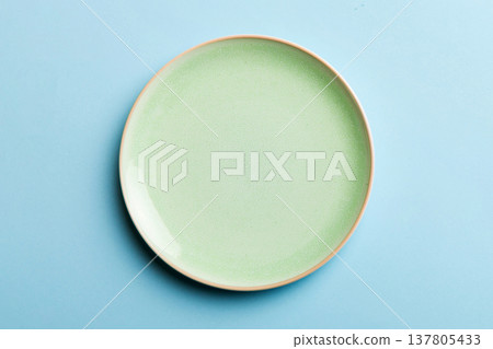 Top view of isolated of colored background empty round green plate for food. Empty dish with space for your design 137805433