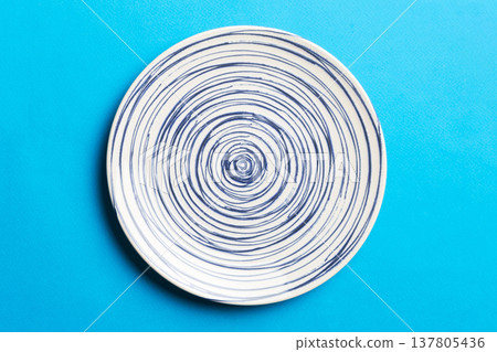 Top view of isolated of colored background empty round blue plate for food. Empty dish with space for your design Top view of isolated of colored background empty round blue plate for food. Empty dish with space for your design 137805436