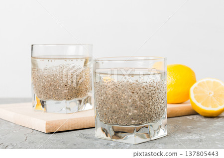 Healthy breakfast or morning with chia seeds and lemon on table background, vegetarian food, diet and health concept. Chia pudding with lemon Healthy breakfast or morning with chia seeds and lemon on table background, vegetarian food, diet and health concept. Chia pudding with lemon 137805443