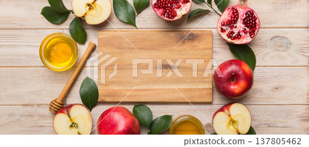 Rosh hashanah, jewish holiday, concept: honey, apple and pomegranate with cutting board, close up 137805462