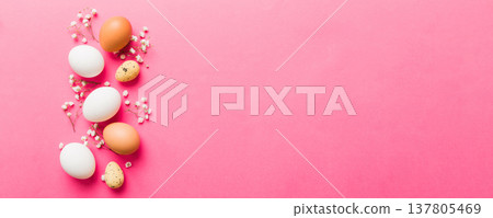 Happy Easter composition. Easter eggs on colored table with gypsophila. Natural dyed colorful eggs background top view with copy space Happy Easter composition. Easter eggs on colored table with gypsophila. Natural dyed colorful eggs background top view with copy space 137805469