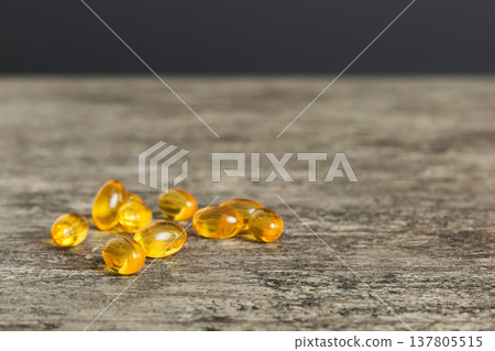 Cod liver oil omega 3 gel capsules on colored background with copy space. Heap of Omega 3 soft gel capsules Cod liver oil omega 3 gel capsules on colored background with copy space. Heap of Omega 3 soft gel capsules 137805515