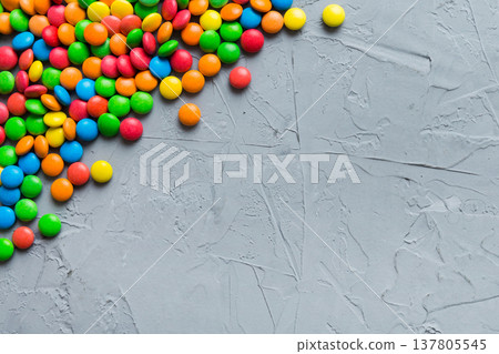 Mixed collection of colorful candy, on colored background. Flat lay, top view. frame of colorful chocolate coated candy Mixed collection of colorful candy, on colored background. Flat lay, top view. frame of colorful chocolate coated candy 137805545
