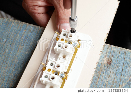 man making an extension cord socket outdoor man making an extension cord socket outdoor 137805564