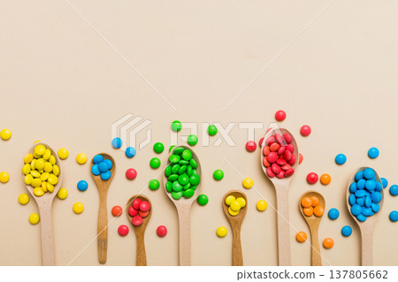 delicious colorful sweet candies on spoon on colored background . Confectionery decor top view with copy space 137805662