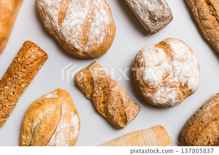Homemade natural breads. Different kinds of fresh bread as background, top view with copy space Homemade natural breads. Different kinds of fresh bread as background, top view with copy space 137805837