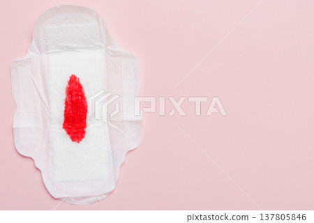 Women hygiene products or Sanitary pad with red feather on colored background. Pastel color. Closeup. Empty place for text. Female daily hygiene Women hygiene products or Sanitary pad with red feather on colored background. Pastel color. Closeup. Empty place for text. Female daily hygiene 137805846