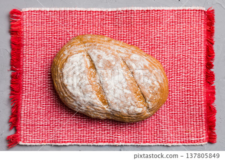 Freshly baked delicious french bread with napkin on rustic table top view. Healthy white bread loaf 137805849