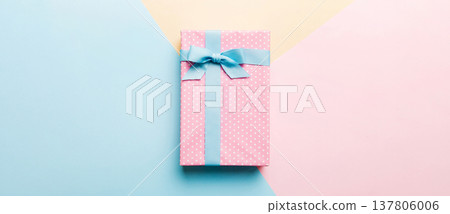 holiday handmade paper present tied blue ribbon bow top view with copy space. Flat lay holiday background. Birthday or christmas present. Christmas gift box concept with copy space 137806006