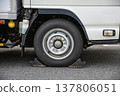 The tires of a truck parked with wheel chocks installed. 137806051