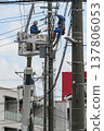 Worker doing electrical work on utility pole 137806053