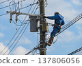 Worker doing electrical work on utility pole 137806056