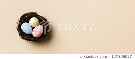 Colorful easter eggs in nest on table background with copy space top view Colorful easter eggs in nest on table background with copy space top view 137806057