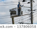 Worker doing electrical work on utility pole 137806058