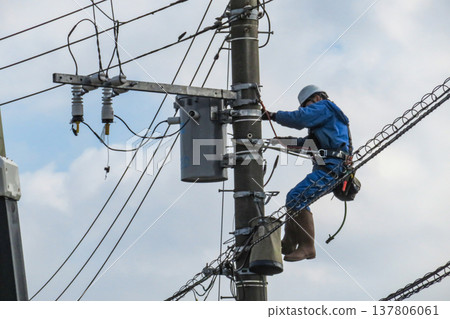 Worker doing electrical work on utility pole Worker doing electrical work on utility pole 137806061