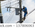 Worker doing electrical work on utility pole 137806063