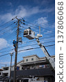Worker doing electrical work on utility pole 137806068