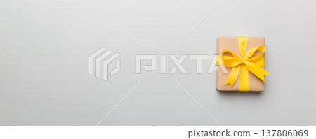 Holiday present box over colored background, top view. Copy space for design Holiday present box over colored background, top view. Copy space for design 137806069