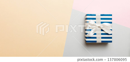 holiday handmade paper present tied white ribbon bow top view with copy space. Flat lay holiday background. Birthday or christmas present. Christmas gift box concept with copy space 137806095