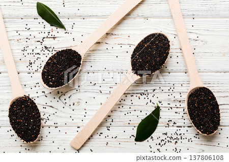 quinoa seeds in spoon on colored background. Healthy kinwa in small spoon. Healthy superfood quinoa seeds in spoon on colored background. Healthy kinwa in small spoon. Healthy superfood 137806108