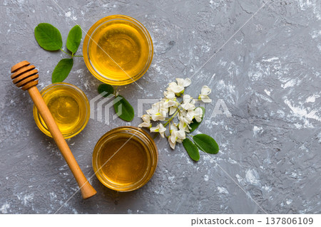 honey jar with acacia flowers and leaves. fresh honey top view flat lay honey jar with acacia flowers and leaves. fresh honey top view flat lay 137806109