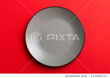 Top view of isolated of colored background empty round gray plate for food. Empty dish with space for your design 137806117