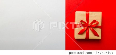 holiday brown paper present tied red ribbon bow top view with copy space. Flat lay holiday background. Birthday or christmas present. Christmas gift box concept with copy space 137806195