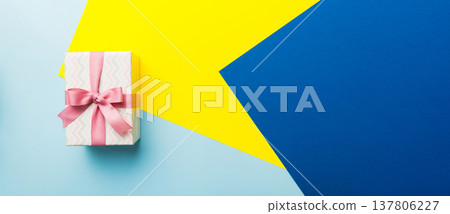 holiday paper present tied pink ribbon bow top view with copy space. Flat lay holiday background. Birthday or christmas present. Christmas gift box concept with copy space holiday paper present tied pink ribbon bow top view with copy space. Flat lay holiday background. Birthday or christmas present. Christmas gift box concept with copy space 137806227