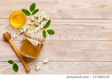 honey jar with acacia flowers and leaves. fresh honey top view flat lay honey jar with acacia flowers and leaves. fresh honey top view flat lay 137806239