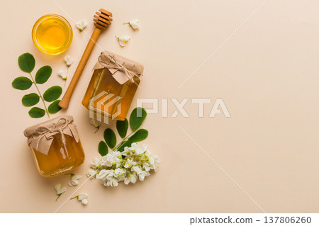 honey jar with acacia flowers and leaves. fresh honey top view flat lay honey jar with acacia flowers and leaves. fresh honey top view flat lay 137806260