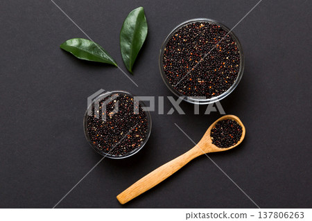 quinoa seeds in bowl and spoon on colored background. Healthy kinwa in small bowl. Healthy superfood 137806263