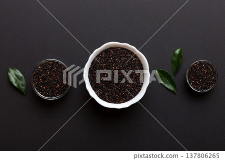 quinoa seeds in bowl on colored background. Healthy kinwa in small bowl. Healthy superfood quinoa seeds in bowl on colored background. Healthy kinwa in small bowl. Healthy superfood 137806265