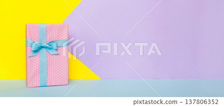 holiday handmade paper present tied blue ribbon bow top view with copy space. Flat lay holiday background. Birthday or christmas present. Christmas gift box concept with copy space holiday handmade paper present tied blue ribbon bow top view with copy space. Flat lay holiday background. Birthday or christmas present. Christmas gift box concept with copy space 137806352
