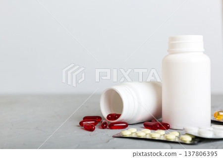 Medicine for treatment HIV infection. Pills and capsules and battle on the table. Different colorful tablets at colored background with copy space Medicine for treatment HIV infection. Pills and capsules and battle on the table. Different colorful tablets at colored background with copy space 137806395