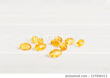 Cod liver oil omega 3 gel capsules on colored background with copy space. Heap of Omega 3 soft gel capsules Cod liver oil omega 3 gel capsules on colored background with copy space. Heap of Omega 3 soft gel capsules 137806415