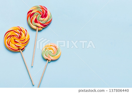 Set of colorful lollipops on colored background. Summer concept. Party Happy Birthday or Minimalist Concept Set of colorful lollipops on colored background. Summer concept. Party Happy Birthday or Minimalist Concept 137806440