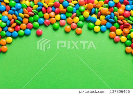 Mixed collection of colorful candy, on colored background. Flat lay, top view. frame of colorful chocolate coated candy 137806466
