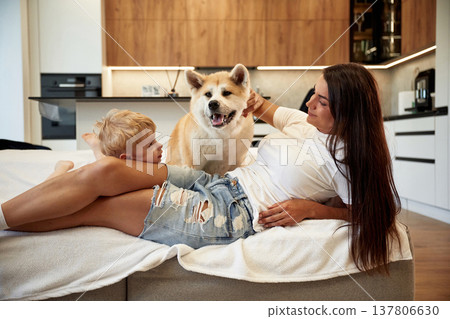 Woman is with her Shibu Inu dog at home 137806630