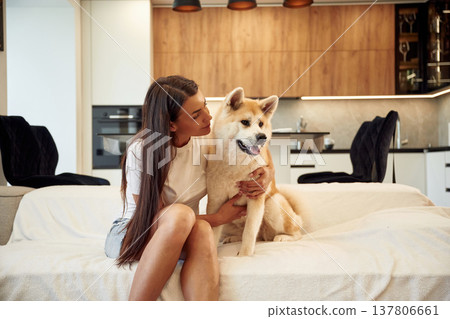 Woman is with her Shibu Inu dog at home Woman is with her Shibu Inu dog at home 137806661