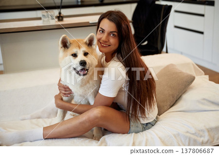 Embracing the pet. Woman is with her Shibu Inu dog at home 137806687